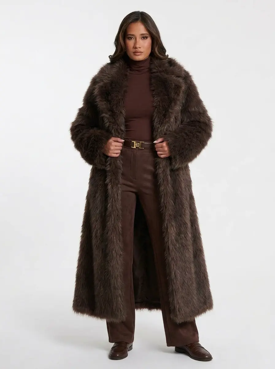Model wearing a long brown faux fur coat with a belted waist