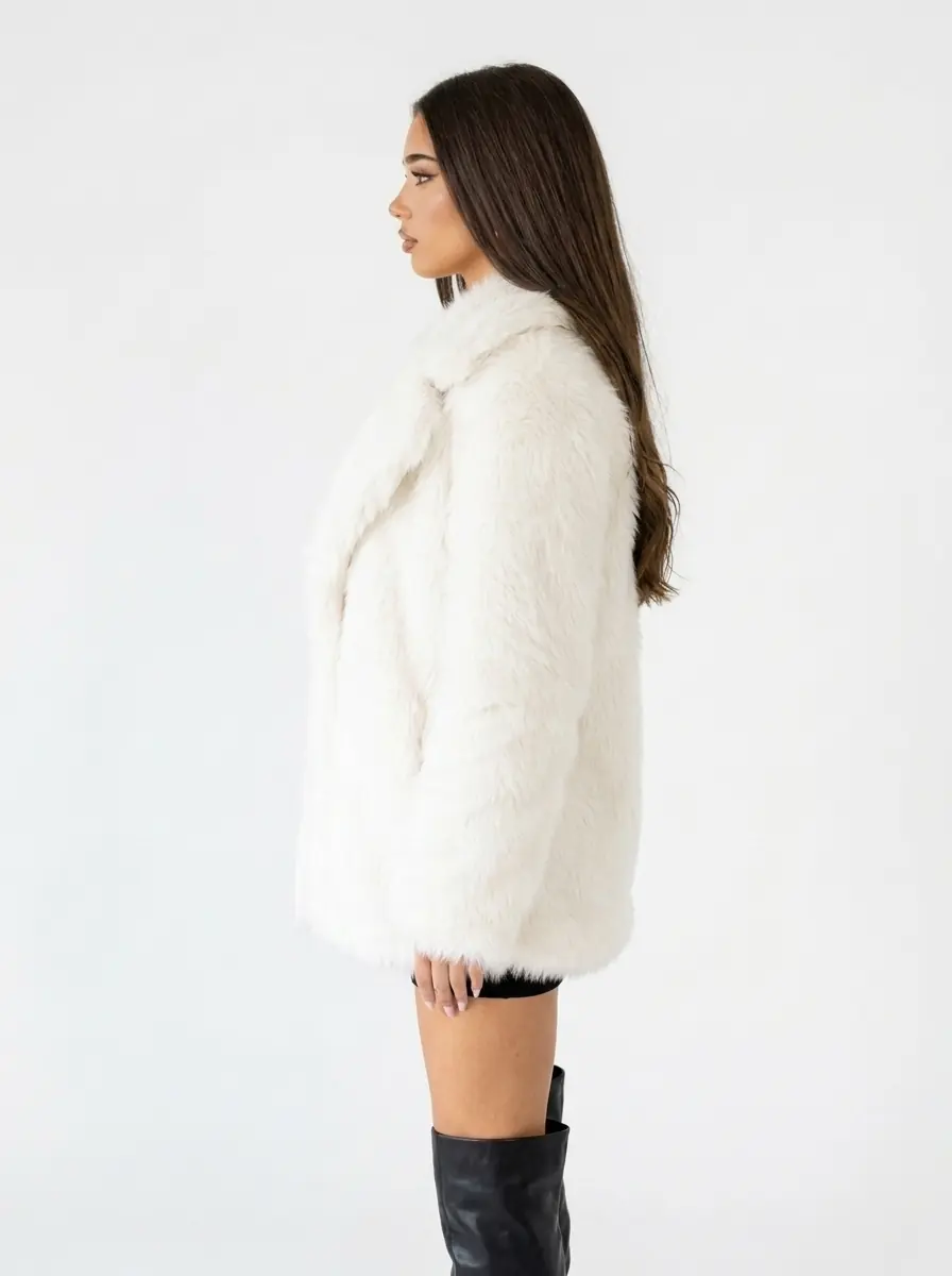 Side view of a women's white faux fur coat