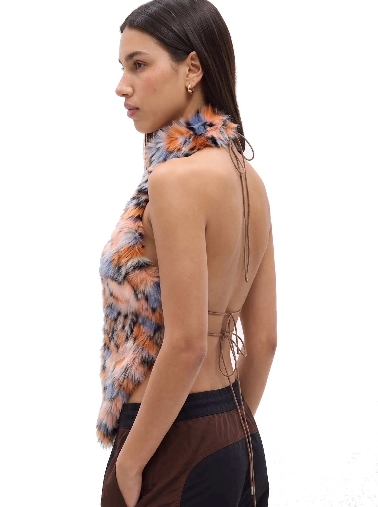 Side profile of a woman wearing an orange and blue spotted faux fur halter vest